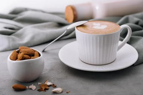 Coffee with almonds on stone table Stock Photos