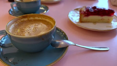 Coffee and cheesecake on the pink table Stock Footage 258598769