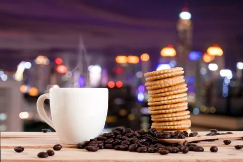 The coffee and cracker snack on table over Cityscape bokeh, Blurred Photo, .. Stock Photos