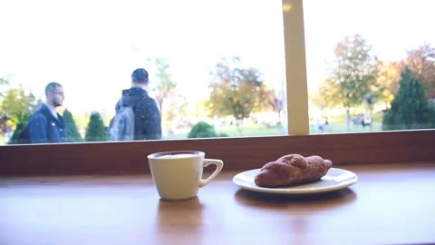 Coffee and croissant on table in cafe Stock Footage 246626983