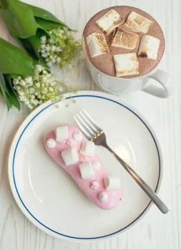 Coffee and eclair the rustic background Stock Photos