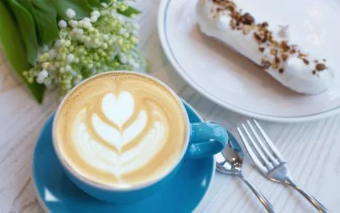 Coffee and eclair the rustic background. Concept and idea Stock Photos