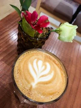 Coffee and flowers on the table Stock Photos