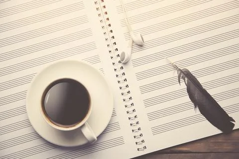Coffee and headset on notebook Stock Photos