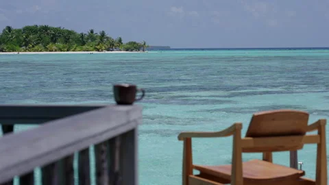 Coffee and Lagoon View from a Gili Lankanfushi Terrace Stock Footage 341102273