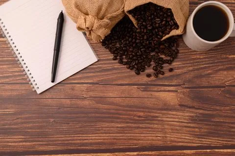 Coffee and a notebook are at your desk. Stock Photos