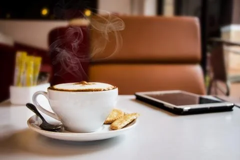 Coffee and tablet on table in cafe Stock Photos