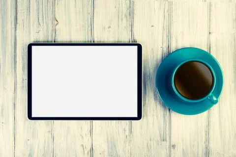 Coffee and tablet on the table Фото