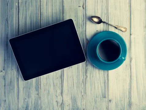 Coffee and tablet on the table Stock Photos