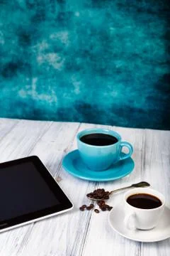Coffee and tablet on the table Stock Photos