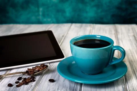 Coffee and tablet on the table Stock Photos