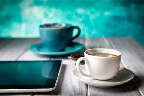 Coffee and tablet on the table Stock Photos