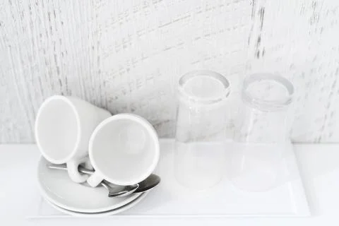 Coffee and tea making set of white cups, saucers, tea spoons and glasses on w Stock Photos
