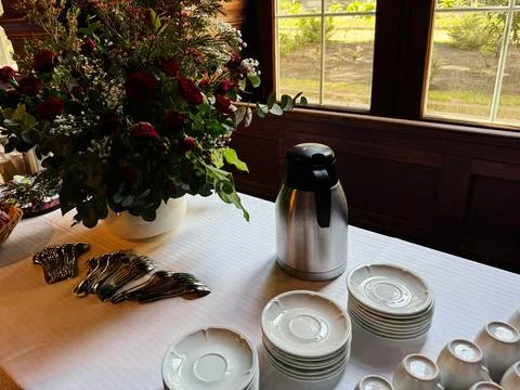 Coffee and tea setup with rose centerpiece on a buffet table at a historic .. Stock Photos