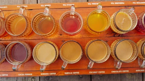 Coffee And Tea Tasting Set Displayed on Wooden Tray With Multiple Flavor Samples Stock Footage 337062927