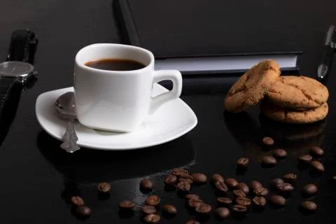 Coffee background with beans and white cup. Dark atmosphere and copy space. O Stock Photos