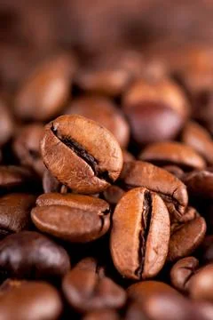 Coffee background. Close up of coffee beans with focus Stock Photos