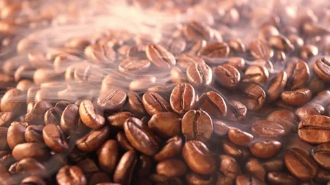 Coffee background. close up of roasted coffee beans with smoke rising and zoom Stock Footage 256497191