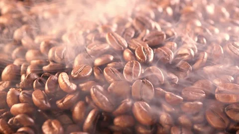 Coffee background. close up of roasted coffee beans with smoke rising and zoom Stock Footage 258743473