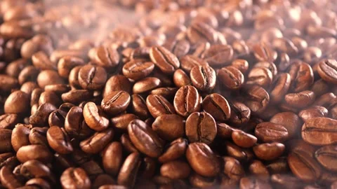 Coffee background. close up of roasted coffee beans with smoke rising and zoom Stock Footage 263714403