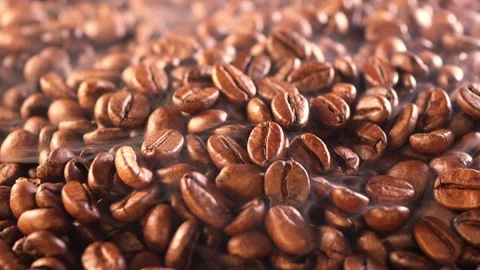 Coffee background. close up of roasted coffee beans with smoke rising and zoom Stock Footage 270410532