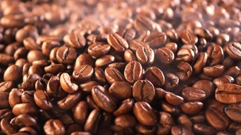 Coffee background. close up of roasted coffee beans with smoke rising and zoom Stock Footage 274134499