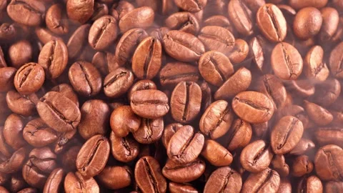 Coffee background. close up of roasted coffee beans with smoke rising and zoom Stock Footage 276742478