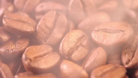 Coffee background. close up of roasted coffee beans with smoke rising and zoom Stock Footage 278394539