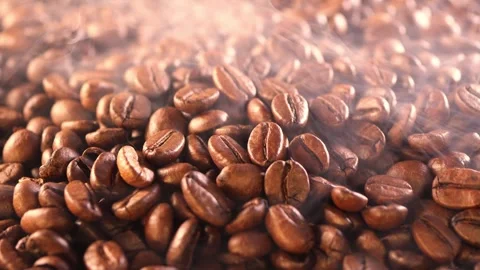 Coffee background. close up of roasted coffee beans with smoke rising and zoom Stock Footage 279821223