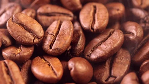 Coffee background. close up of roasted coffee beans with smoke rising and zoom Stock Footage 279821243