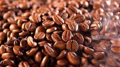 Coffee background. close up of roasted coffee beans with smoke rising and zoom Stock Footage 282208942