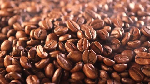 Coffee background. close up of roasted coffee beans with smoke rising and zoom Stock Footage 286146162