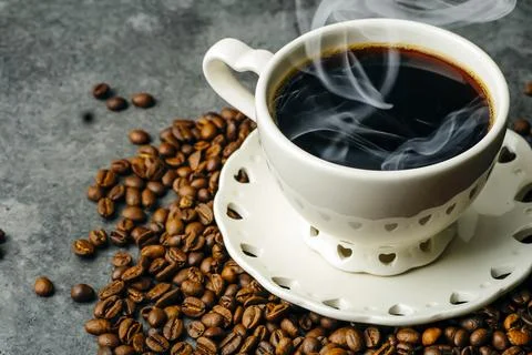 Coffee background. Coffee beans and cup on dark backgrpund. Coffee banner for Stock Photos