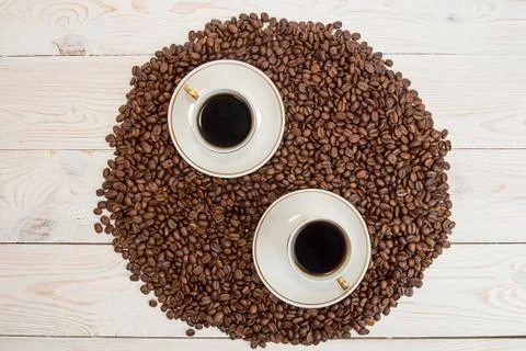 Coffee background. Coffee beans in circle shape with cup of coffee Stock Photos