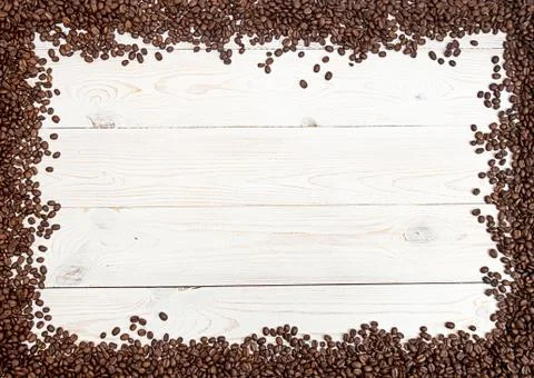Coffee background. Coffee beans spread on table on four sides. Stock Photos