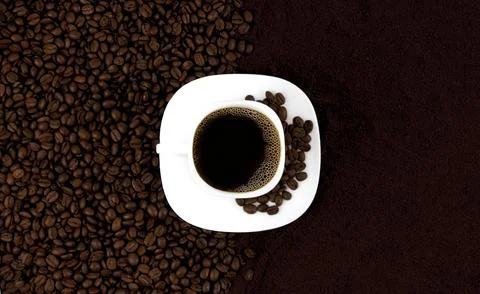 Coffee background. A cup of coffee on a background of coffee beans and grou.. Stock Photos