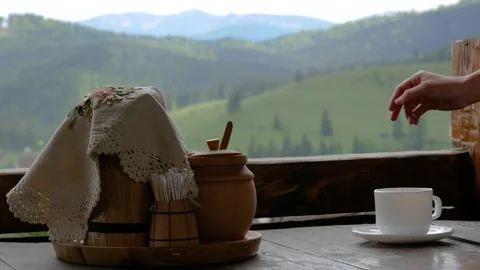 Coffee on a background of mountains, hand lays sugar Stock Footage 130797086
