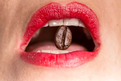Coffee bean between tooths Stock Photos