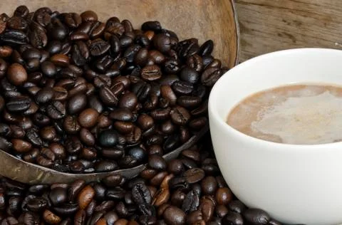 Coffee bean in coconut shell Stock Photos
