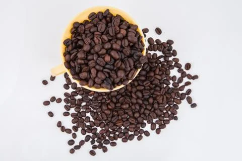 Coffee bean on the cup and on  white background Stock Photos