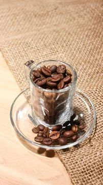 Coffee bean fall down pour in glass bowl, Coffee seeds float explode, abstr.. Stock Photos