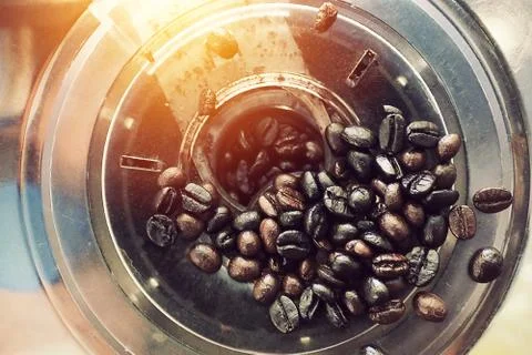 Coffee bean grinding inside grinder machine photo from above top view Stock Photos