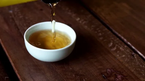 Coffee bean husks being poured into a ceramic cup. Stock Footage 250709376