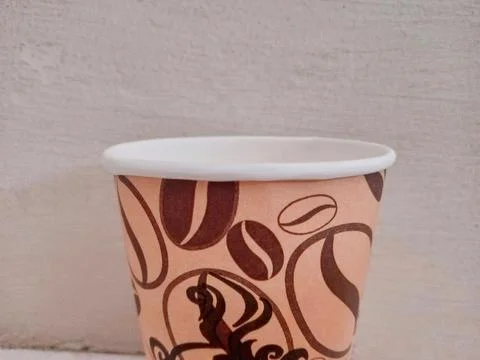 Coffee Bean Pattern Paper Cups on Neutral Background Stock Photos