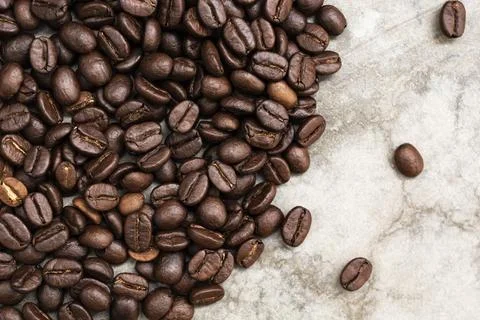 Coffee bean texture on stone background copy space. Stock Photos