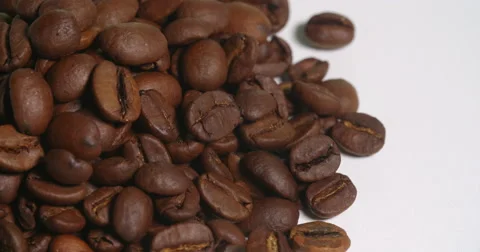 Coffee Beans Above Pile Close Up Edge on White Spins Stock Footage 64974515