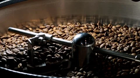 Coffee beans after roasting are mixed on the cooling plate. Stock Footage 310846168