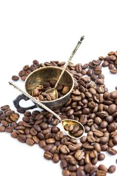 Coffee beans and antuque cup and spoons on white background Stock Photos