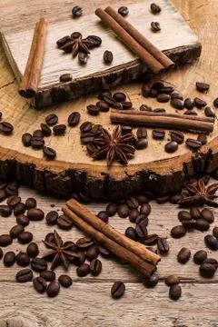 Coffee beans and cinnamon on rustic surface Stock Photos