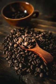 Coffee Beans and Cup on Rustic Wooden Table Stock Photos